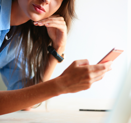 Young female businesswoman in the office near desk.の写真素材