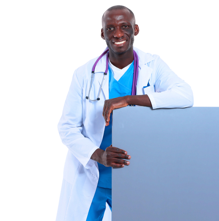 Male doctor holding empty placard standing on white background.の写真素材