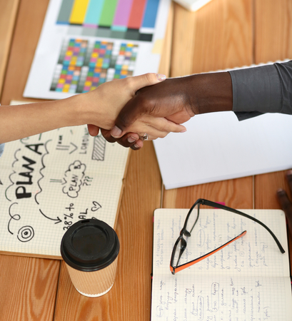 Business people handshake sitting on the desk in office.の写真素材