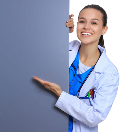 A female doctor with a blank billboard.の写真素材