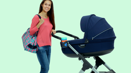 Full length portrait of a mother with a stroller, isolated on white backgroundの写真素材