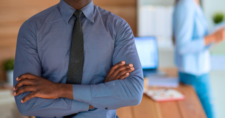 African-American Businessman over business office background.の写真素材