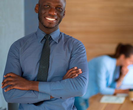African-American Businessman over business office backgroundの写真素材