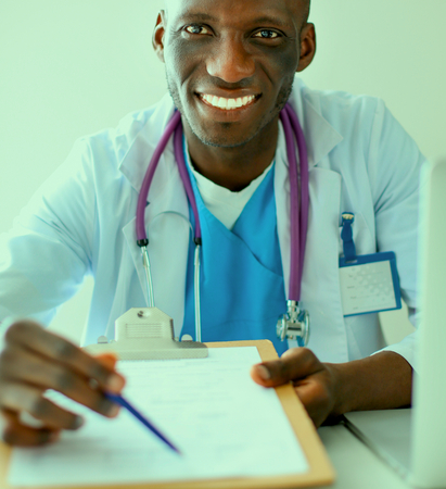 Male doctor sitting at his deskの写真素材