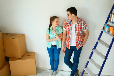 Portrait of young couple moving in new home.の写真素材