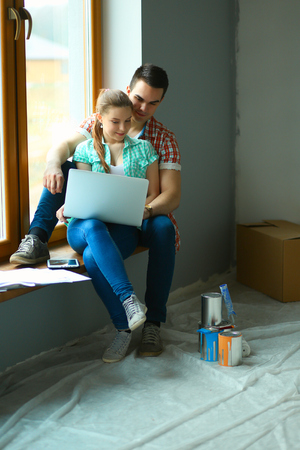 Portrait of young couple moving in new home.の写真素材