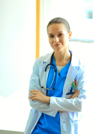 Woman doctor standing at hospital near window.の写真素材