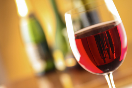 Glass of red wine and the wine bottle.の写真素材