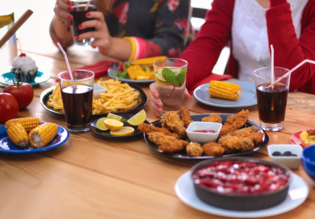Top view of group of people having dinner together while sitting at wooden tableの写真素材