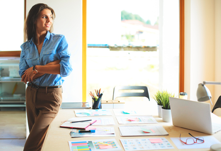 Young female businesswoman in the office near desk.の写真素材