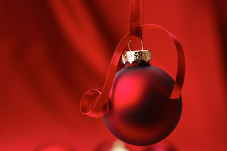 Christmas red balls on a bowl, on red background.の写真素材