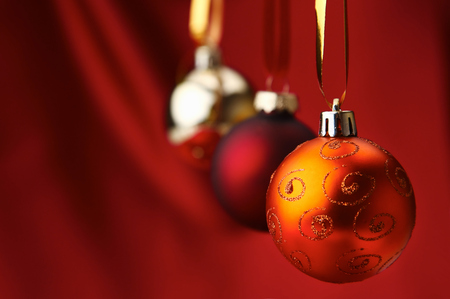 Christmas red balls on a bowl, on red background.の写真素材