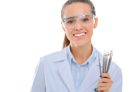 Beautiful female dentist doctor holding and showing toothbrush isolated on a white background.の写真素材