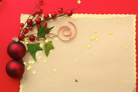 Christmas card with red balls and gold stars.の写真素材