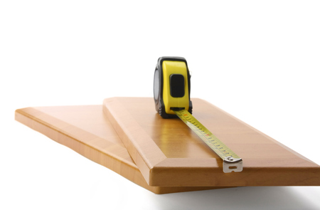 Wooden board and tools on a white background.の写真素材