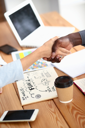 Business people handshake sitting on the desk in office.の写真素材