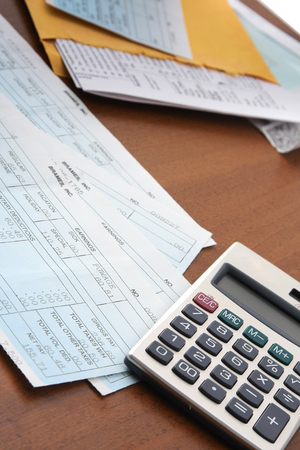 Calculator with business paper on the desk.の写真素材