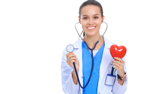 A doctor with stethoscope examining red heart, isolated on white background.の写真素材
