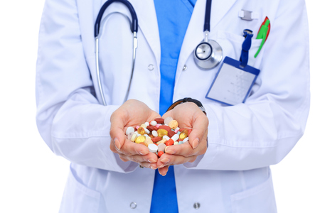 Doctor holding heap of drugs in a hand.の写真素材