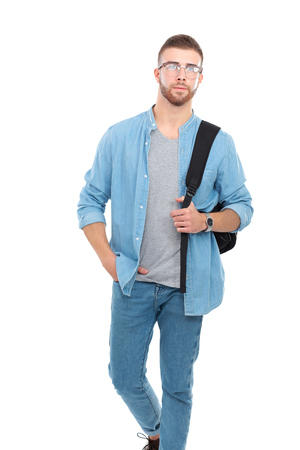 A male student with a school bag holding books isolated on white backgroundの写真素材