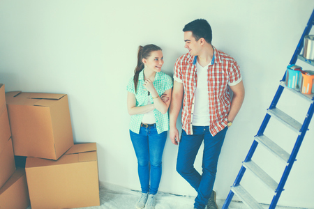 Portrait of young couple moving in new home.の写真素材