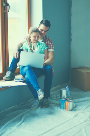 Portrait of young couple moving in new home.の写真素材