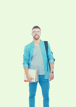 A male student with a school bag holding books isolated on white backgroundの写真素材