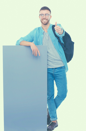 Portrait of a smiling male student holding blank board.の写真素材