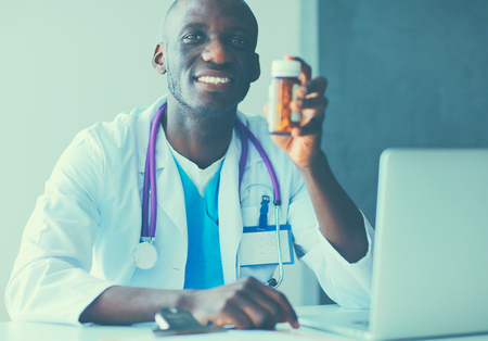Close-up of male doctor giving jar of pills to patient.の写真素材