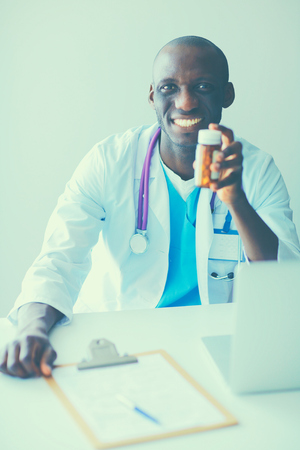 Close-up of male doctor giving jar of pills to patient.の写真素材