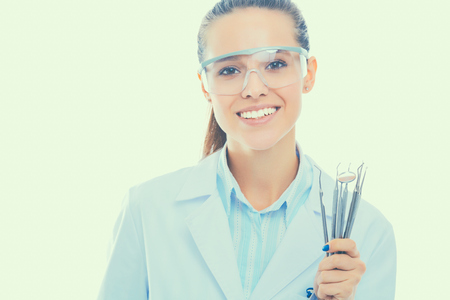 Beautiful female dentist doctor holding and showing toothbrush isolated on a white background.の写真素材