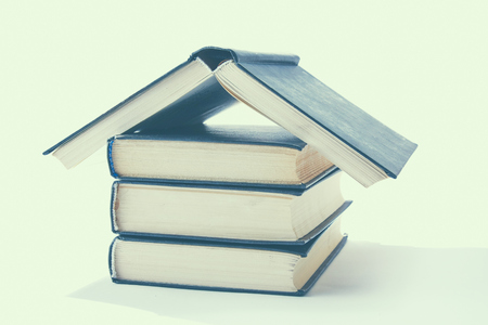House made with books piled on white .の写真素材
