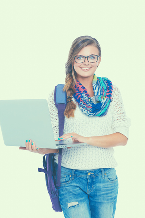 Smiling teenager with laptop on white background.の写真素材