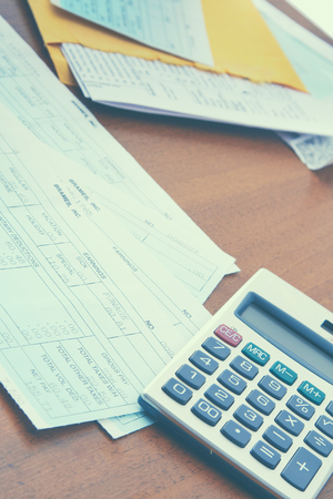 Calculator with business paper on the desk.の写真素材