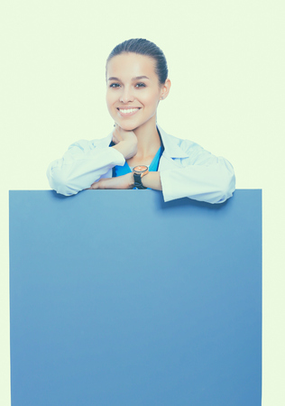 A female doctor with a blank billboard.の写真素材