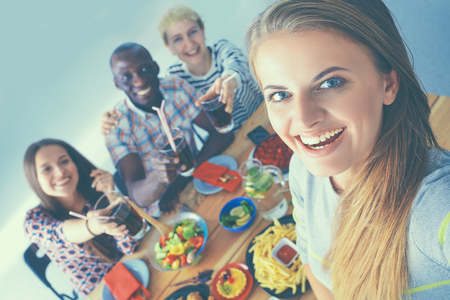 Group of people doing selfie during lunch.の写真素材