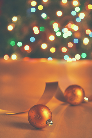 Gold balls with tape on a christmas background.の写真素材
