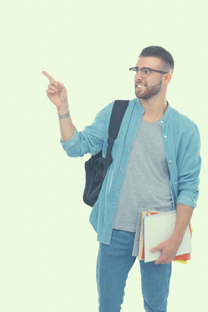 A male student with a school bag holding books isolated on white backgroundの写真素材