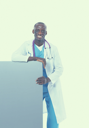 Male doctor holding empty placard standing on white background.の写真素材