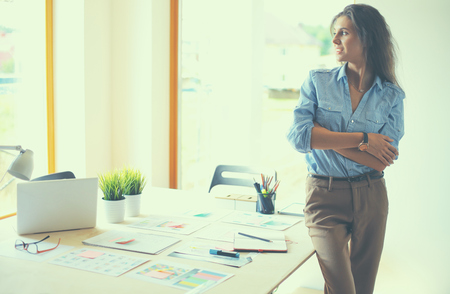 Young female businesswoman in the office near desk.の写真素材