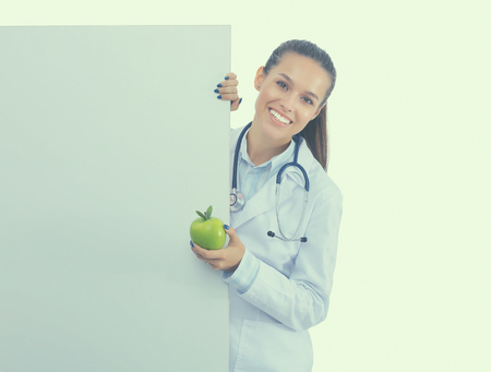 Smiling doctor with apple and blank banner.の写真素材