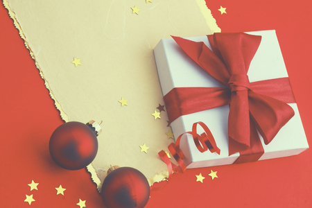 Christmas gift box card with red balls and gold stars.の写真素材