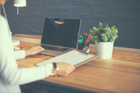 Young female working sitting at a desk.の写真素材