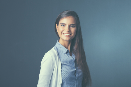 Portrait of a businesswoman , against dark background.の写真素材