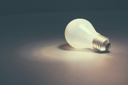 One bright light isolated on black background.の写真素材