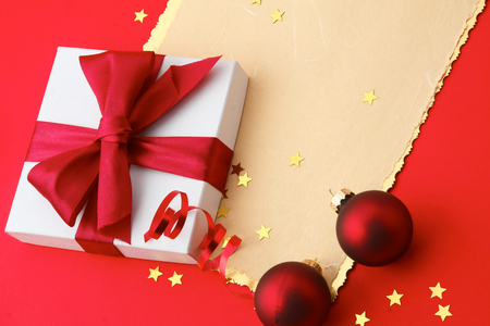 Christmas gift box card with red balls and gold stars.の写真素材