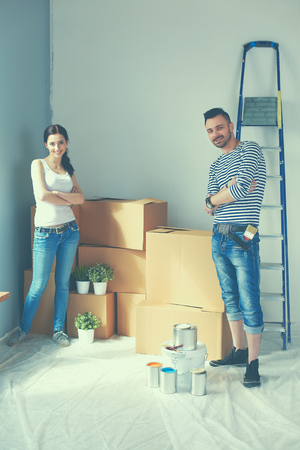 Happy young couple unpacking or packing boxes and moving into a new home.の写真素材