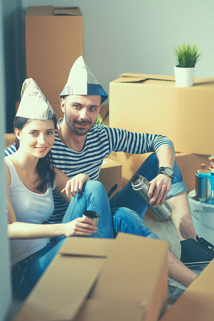 Couple moving in house sitting on the floor.の写真素材