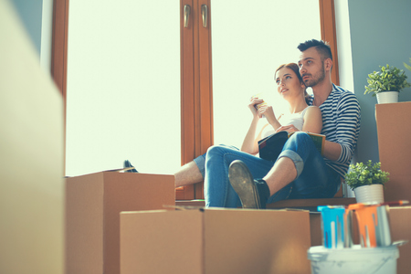 Couple moving in house sitting on the windowsill.の写真素材