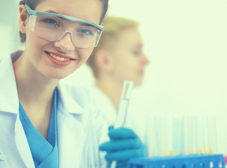 Woman researcher is surrounded by medical vials and flasks, isolated on white backgroundの写真素材